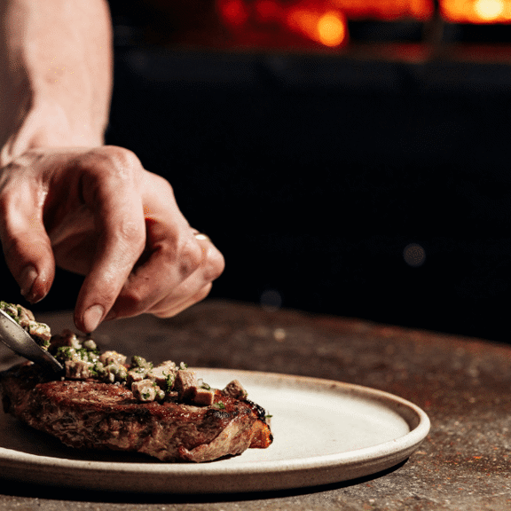 Chef plating food at Daffodil Mulligan restaurant in Shoreditch