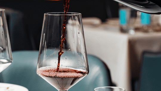 Red wine being poured into a wine glass