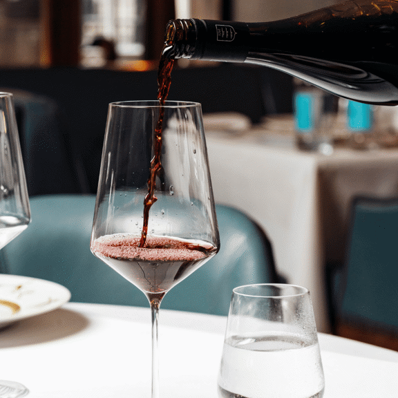 Red wine being poured into a wine glass