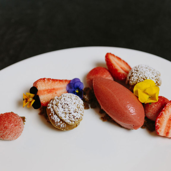 Dessert and sorbet on a plate with flowers from Corrigan's Mayfair