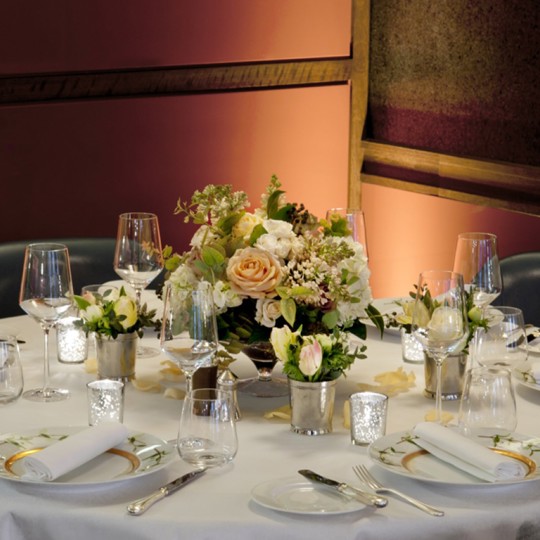 Table laid at Corrigan's Mayfair with a flower centrepiece 