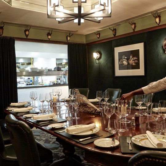 Man laying a table at Corrigan's Mayfair