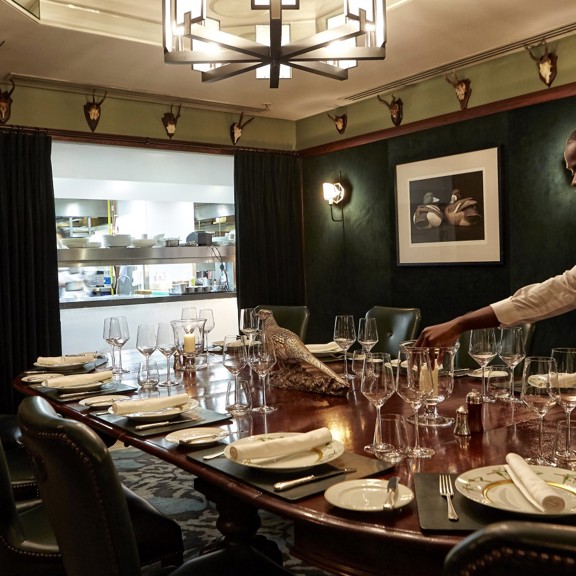 Man laying a table at Corrigan's Mayfair