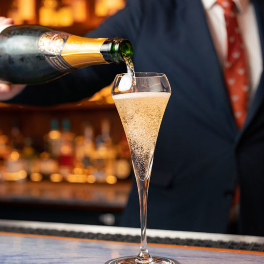 Man pouring champagne into a champagne glass
