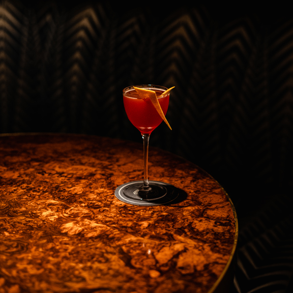 Cocktail on a wooden table from Corrigan's Mayfair